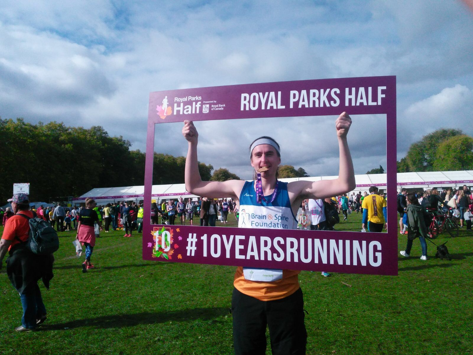 A runner holds up a Royal Parks Half Marathon sign